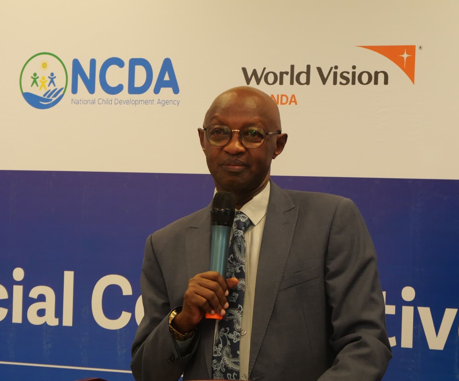 A speaker addressing a child rights event with NCDA and World Vision